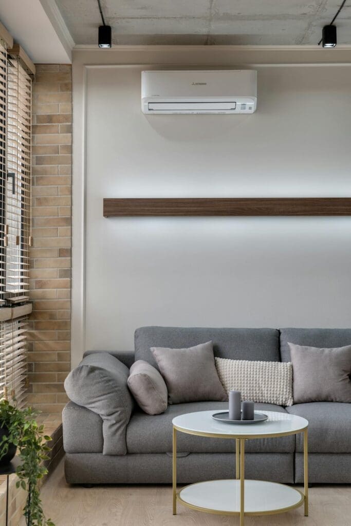 Living room with AC unit showing why hvac repair reno nv service can help improve indoor comfort